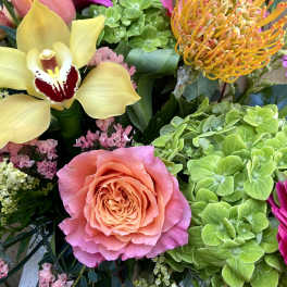 Mixed bouquet with a pink rose, yellow orchid, and bright gerbera daisies