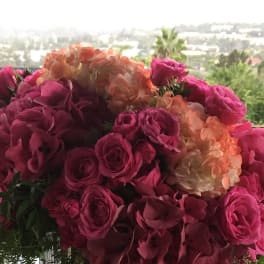 Pink roses and peach hydrangeas in a clear glass vase