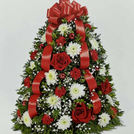 Christmas tree-shaped floral arrangement with red ribbons and red and white flowers