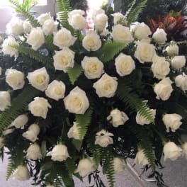 Large arrangement of white roses with fern foliage