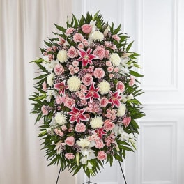Standing floral spray with pink and white flowers on an easel
