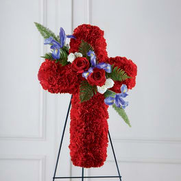 Red floral cross on a black stand with blue accents