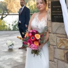 Bride holding a colorful bouquet of mixed flowers