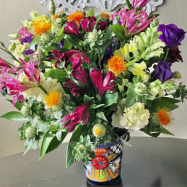 Colorful mixed bouquet in a painted ceramic vase