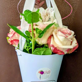Pink and white roses in a white hanging cone holder
