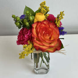 Colorful mixed bouquet in a clear glass vase