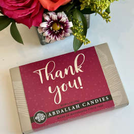 Flowers beside a thank-you candy box