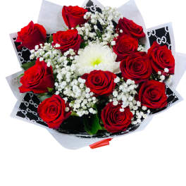 Bouquet of red roses with white filler flowers and a white bloom