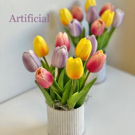 Artificial tulips in a small striped pot