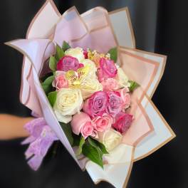 Bouquet of pink and white roses wrapped in pastel paper