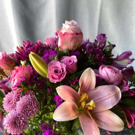 Bouquet of pink lilies, roses, and purple flowers
