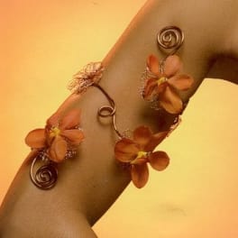 Orange flower wrist corsage with curled wire accents