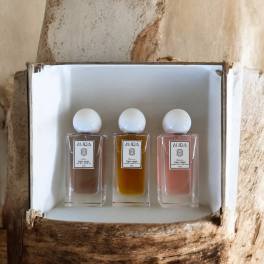 Three small perfume bottles in a white box