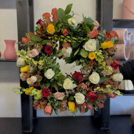 Circular wreath of multicolored roses and greenery
