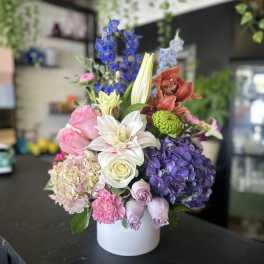 Colorful mixed flower arrangement in a white vase