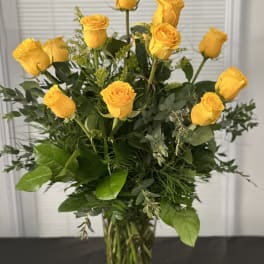 Yellow roses arranged in a clear glass vase