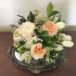 Peach and white bouquet with tulips and roses in an ornate tray