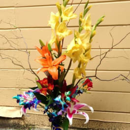 Tall arrangement of colorful lilies in a vase