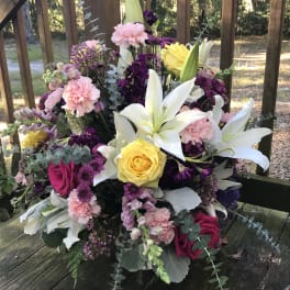 Bouquet with white lilies, yellow and pink roses, and purple flowers