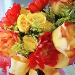 Bouquet of yellow and red roses with striped ribbon
