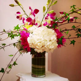 Pink and white floral arrangement in a glass vase