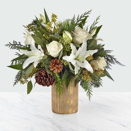 White lilies and roses in a wooden vase with pinecones