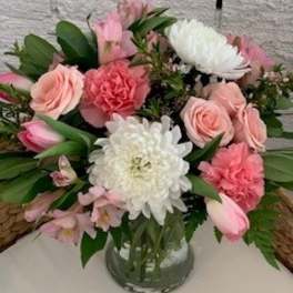 Pink and white mixed flower arrangement in a glass vase