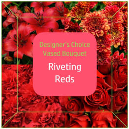 Red mixed flowers with a pink label reading Riveting Reds