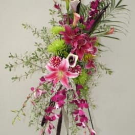 Tall floral arrangement with pink lilies and purple orchids