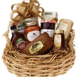 Gift basket with jams, honey, and packaged treats in a wicker basket