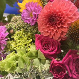 Mixed bouquet with pink dahlias, roses, and purple blooms