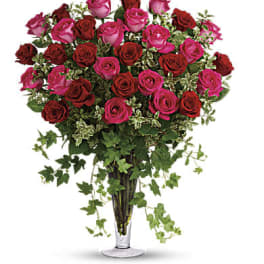 Bouquet of pink and red roses in a clear glass vase
