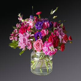 Mixed pink and purple bouquet in a clear glass vase