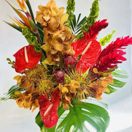 Tropical bouquet with red anthuriums, yellow orchids, and bird-of-paradise