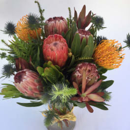 Bouquet of protea flowers in a glass vase