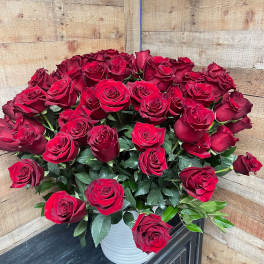 Bouquet of red roses in a white vase