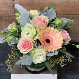 Pastel bouquet with roses, gerbera daisy, and lisianthus in a vase