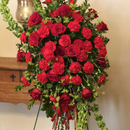 Standing red rose and carnation spray on an easel