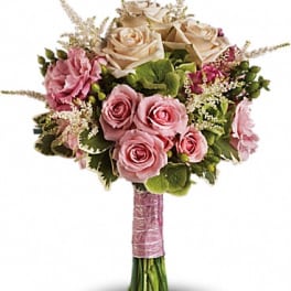 Pink and cream rose bouquet with green accents and a wrapped handle