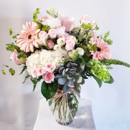 Pink and white mixed flower bouquet in a clear glass vase