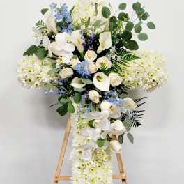 White floral standing spray with orchids, roses, and chrysanthemums