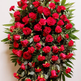 Large standing spray of red roses and carnations on an easel