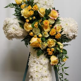 Cross-shaped floral spray with yellow roses and white chrysanthemums
