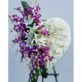 Standing floral spray with white lilies, purple orchids, and white roses