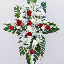 Standing floral cross with red and white roses and daisies