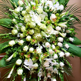 Large white and green floral standing spray with orchids and roses