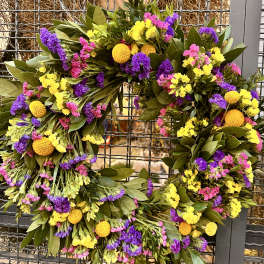Colorful floral wreath with yellow, purple, and pink blooms