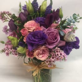 Purple and pink mixed bouquet in a glass vase