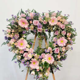 Heart-shaped floral wreath with pink roses and gerbera daisies