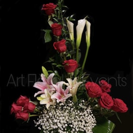 Tall arrangement of red roses, pink lilies, and white calla lilies